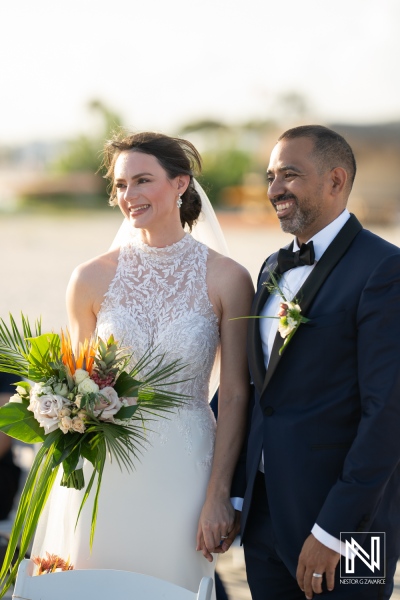 Celebration of love at sunset during a wedding ceremony on the beach at Curacao Marriott Beach Resort