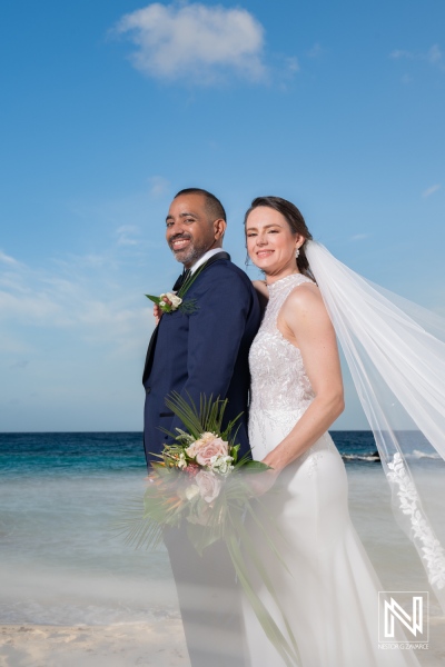 Couple celebrates love during sunset wedding ceremony at a tropical beach in Curacao with picturesque views