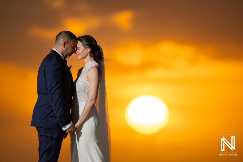 Wedding ceremony at sunset by the beach in Curacao Marriott Beach Resort surrounded by love and romance