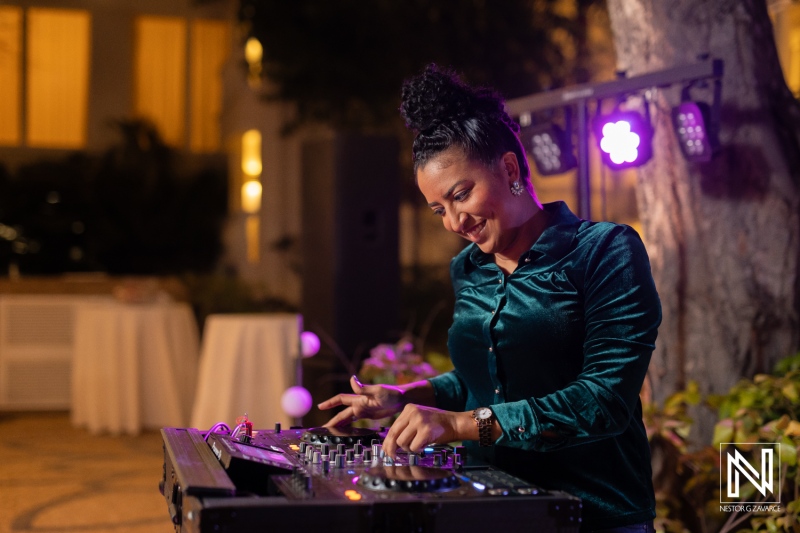 DJ plays vibrant music at a wedding during sunset at Curacao Marriott Beach Resort