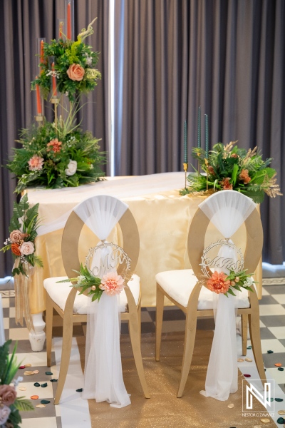 Wedding ceremony setup at Avila Beach Hotel in Curacao with decorated chairs and floral arrangements