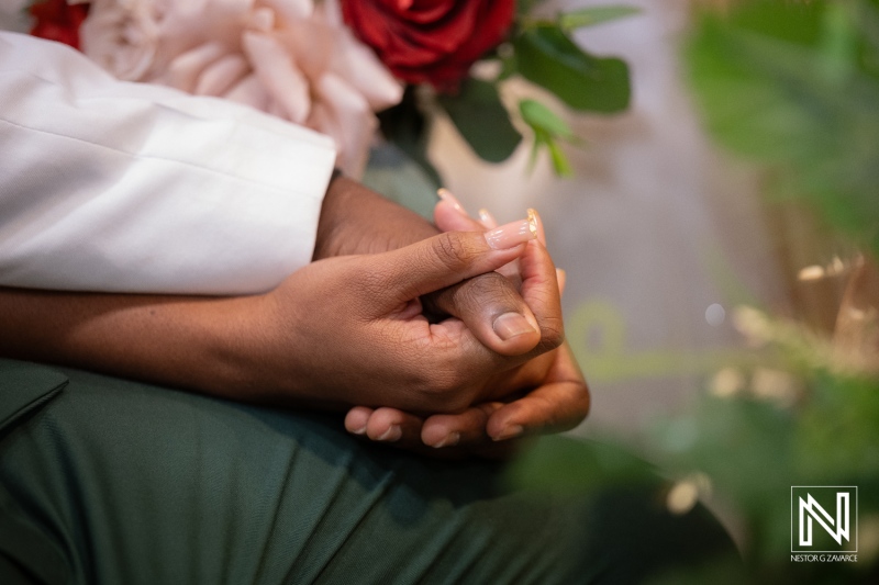 Couple holds hands during a wedding ceremony at Avila Beach Hotel in Curacao