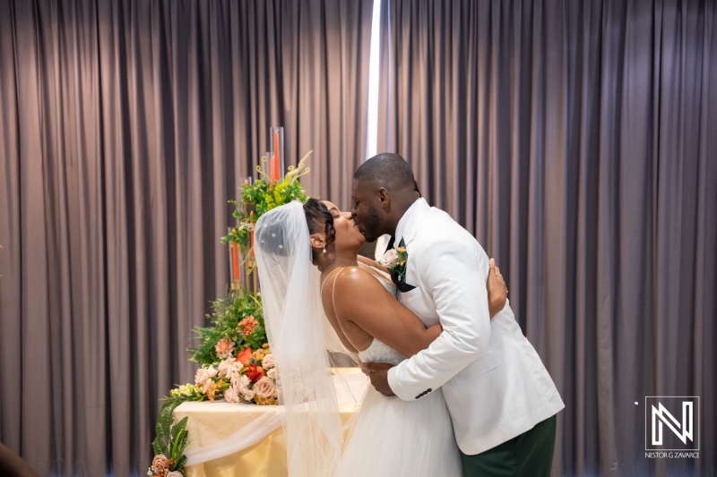 Couple shares a kiss during wedding ceremony at Avila Beach Hotel in Curacao