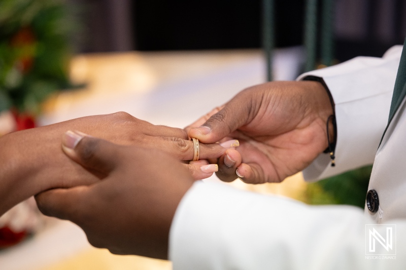 Couple exchanges wedding rings during ceremony at Avila Beach Hotel in Curacao