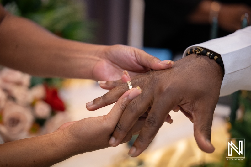 Wedding ceremony taking place at Avila Beach Hotel in Curacao with exchanging of rings