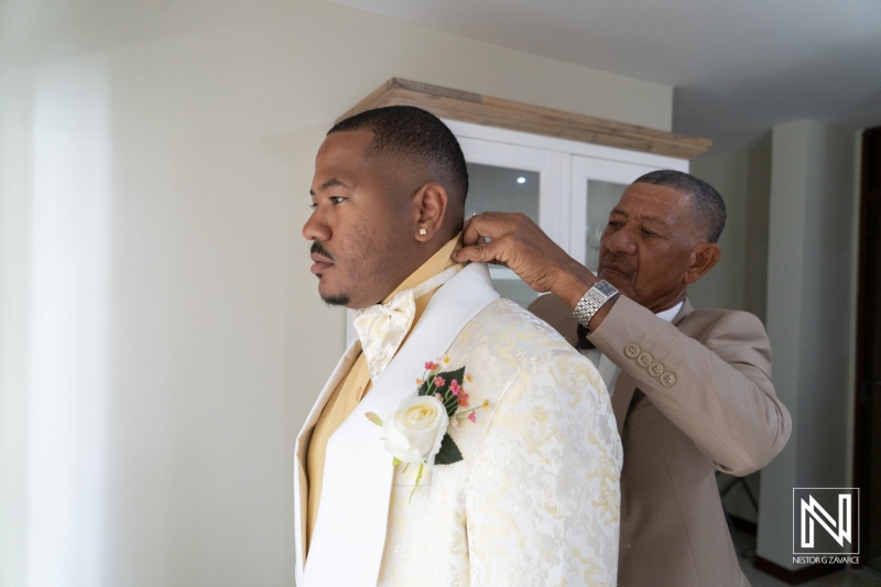 Groom getting into attire