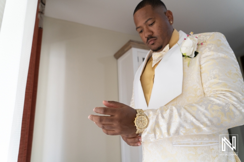 Groom getting into attire