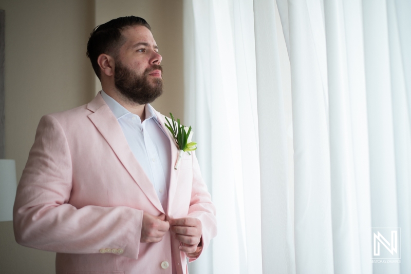 Groom getting into attire
