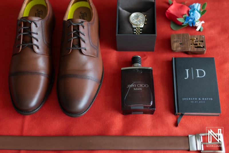 Wedding details displayed at Dreams Curacao Resort Spa Casino with shoes, watch, cologne, and other essentials for the groom