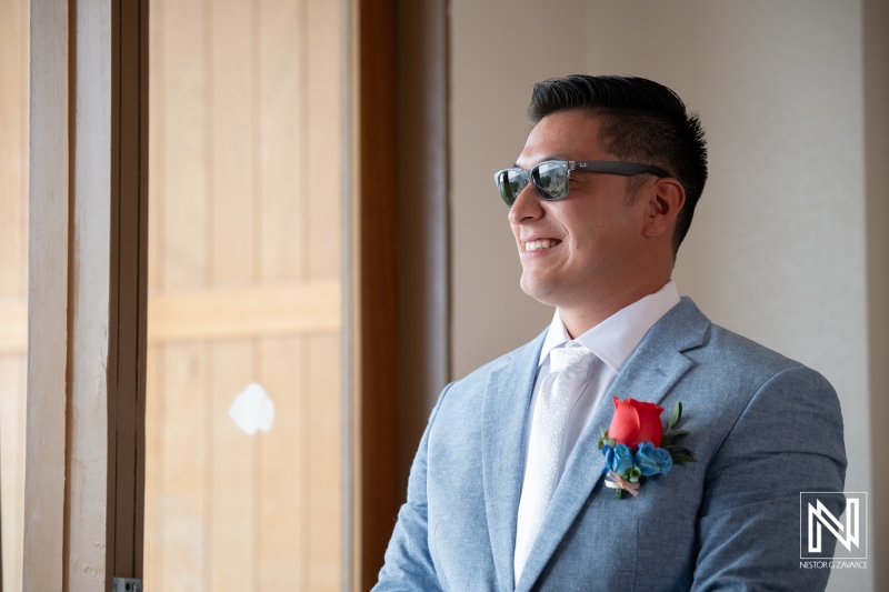 Groom prepares for wedding at Dreams Curacao Resort Spa Casino on a sunny day
