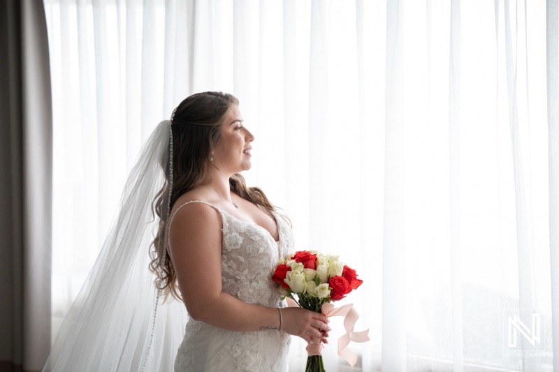 Bride prepares for wedding at Dreams Curacao Resort in morning light with floral bouquet