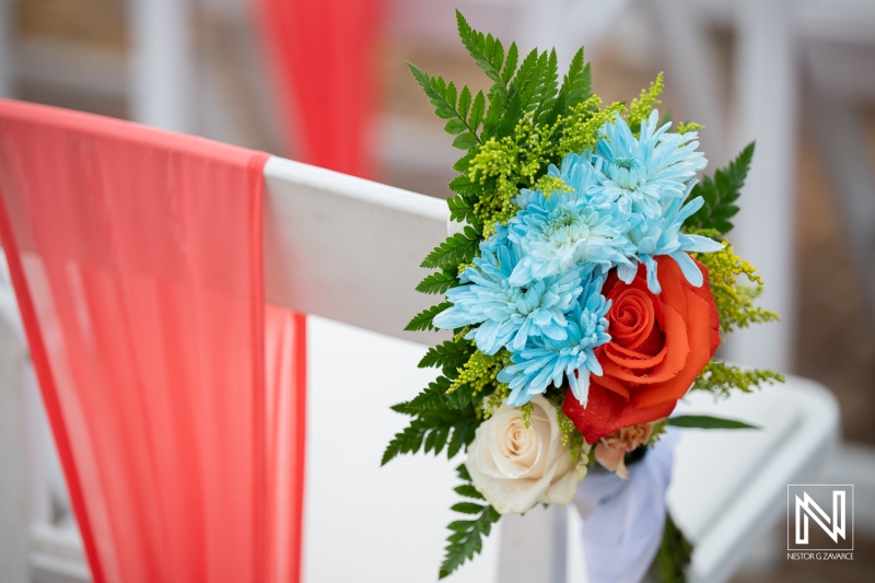 Wedding decoration at Dreams Curacao Resort featuring a floral arrangement and a beautiful setting by the ocean