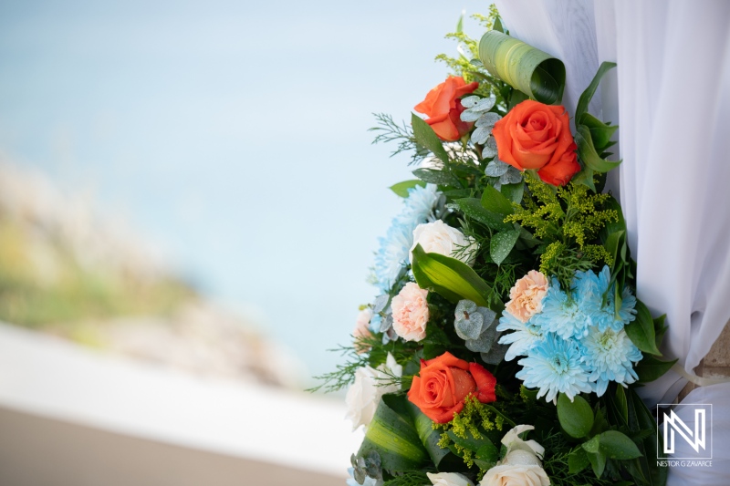 Wedding celebration at Dreams Curacao Resort with floral decorations near the ocean