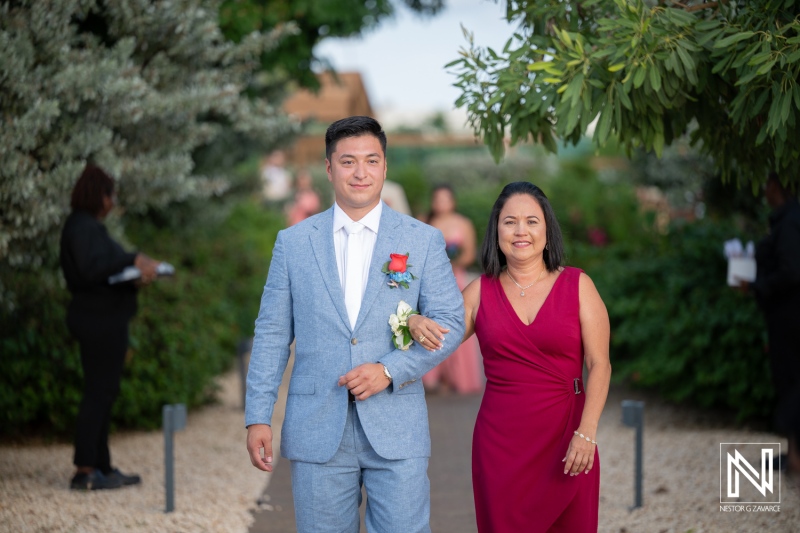Wedding ceremony at Dreams Curacao Resort Spa Casino with family members walking down the aisle