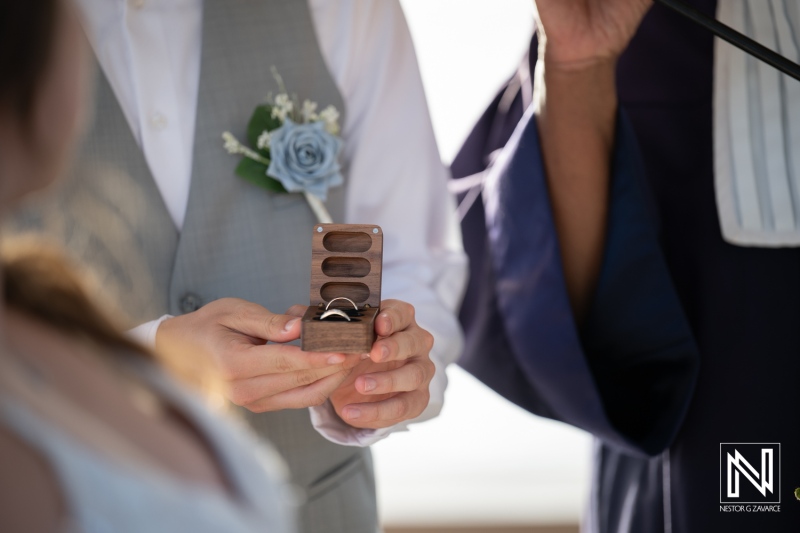 Wedding ceremony at Dreams Curacao Resort Spa Casino with rings in hand and vows exchanged by the couple