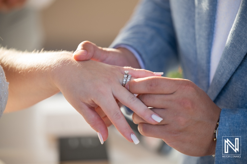 Couple exchanges wedding rings during ceremony at Dreams Curaçao Resort Spa Casino in Curaçao