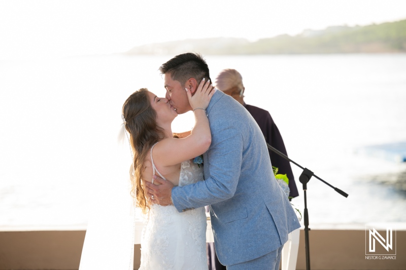 Couple shares a kiss during wedding ceremony at Dreams Curacao Resort, Spa, and Casino in Curacao
