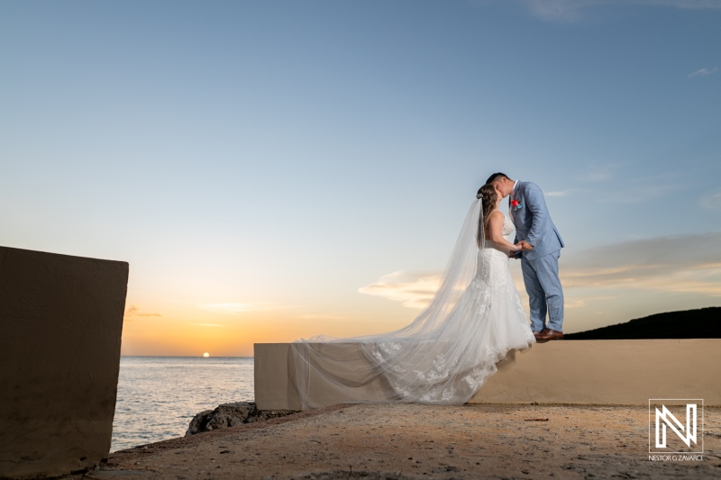 Couple shares a moment during their wedding at Dreams Curacao Resort in the evening light