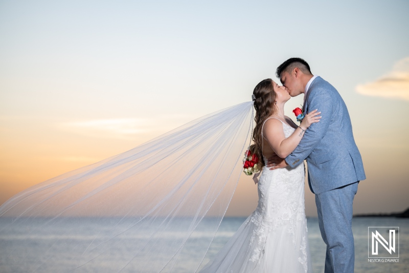 Couple shares a moment during their wedding at Dreams Curacao Resort, Spa Casino in Curacao at sunset