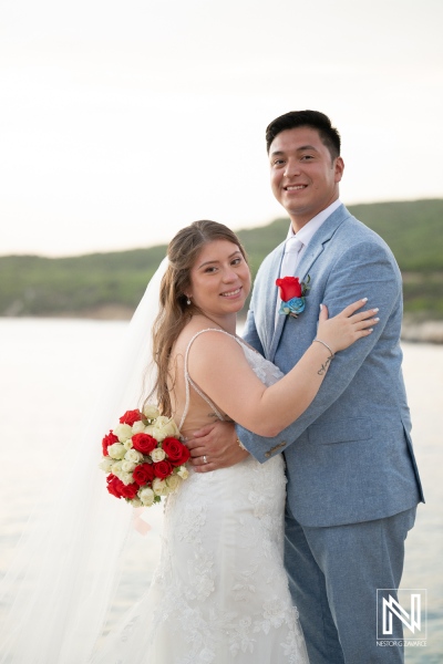 Couple celebrates wedding at Dreams Curacao Resort Spa Casino during sunset near the water