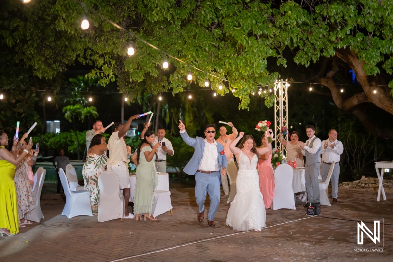 Couples celebrate wedding ceremony at Dreams Curacao Resort with lively dancing and joyful guests in the evening