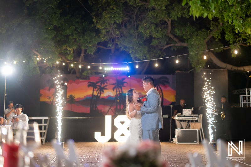 Outdoor wedding celebration at Dreams Curacao Resort with couple dancing at night
