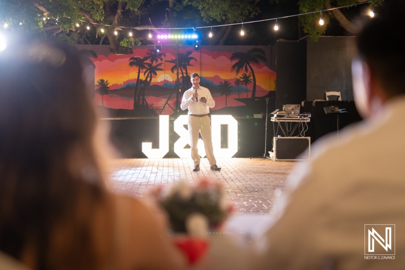 Wedding ceremony at Dreams Curacao Resort, Spa and Casino with couple and guests sharing special moments at sunset