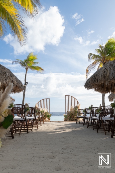 Wedding ceremony at Renaissance Wind Creek in Curacao with chairs arranged on the beach facing the ocean