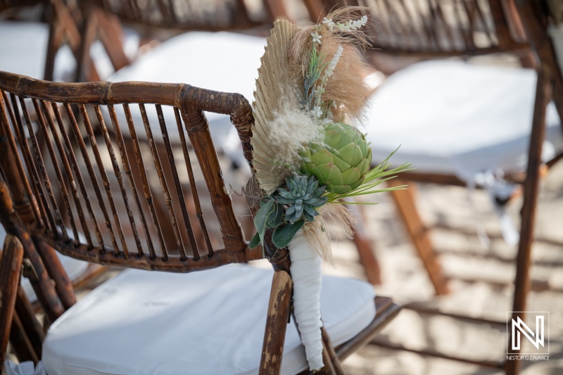 Wedding ceremony setup at Renaissance Wind Creek in Curacao featuring floral decorations on chairs