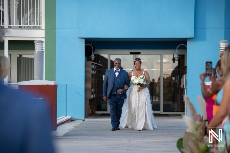 Couple walks down path at wedding ceremony at Renaissance Wind Creek in Curacao