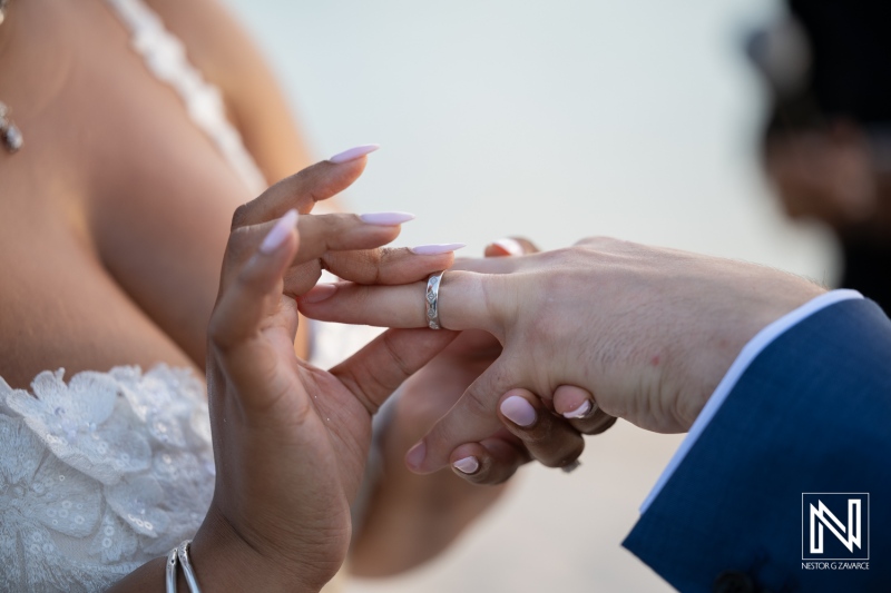Couple exchanges wedding rings at Renaissance Wind Creek in Curacao
