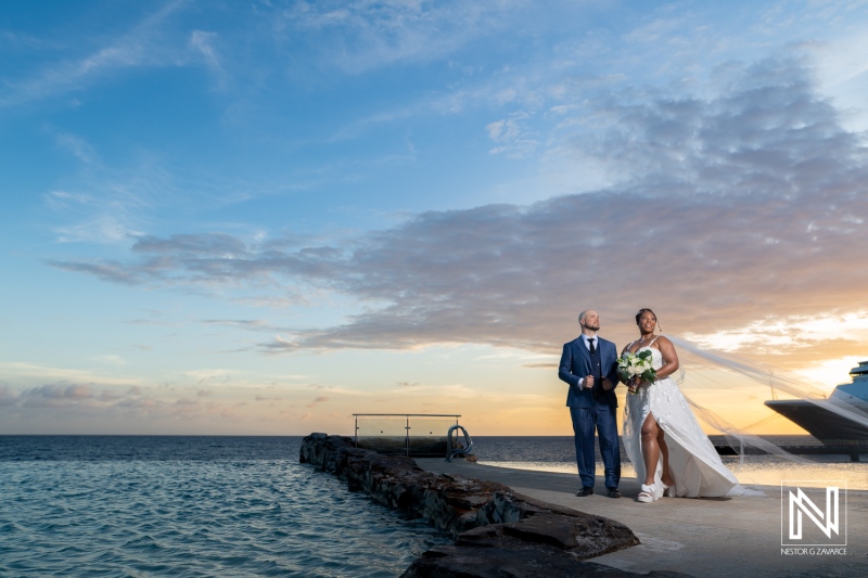 Couple enjoys their wedding ceremony at Renaissance Wind Creek in Curacao during sunset
