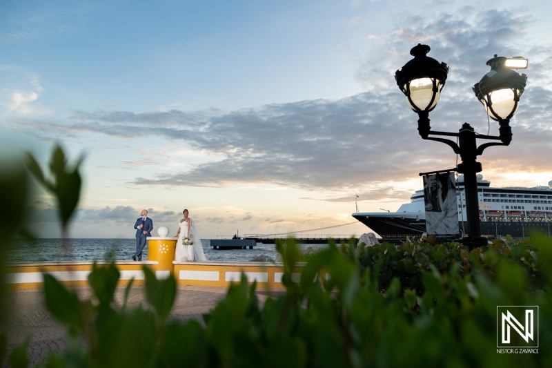 Couple celebrates wedding at Renaissance Wind Creek in Curacao during evening with ocean backdrop and soft lighting