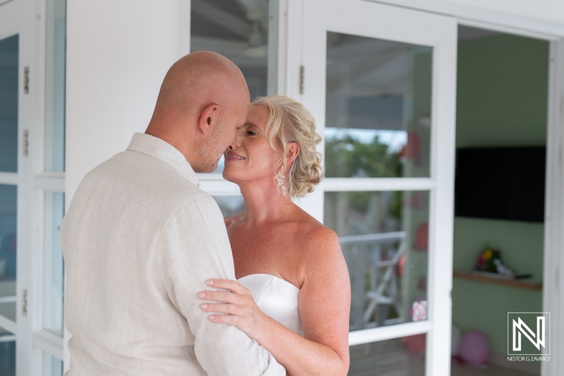 Couple shares an intimate moment during their wedding ceremony at Papagayo Beach Resort in Curacao