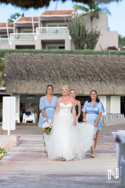 Bride walking with bridesmaids at Karakter in Curacao during an outdoor wedding celebration