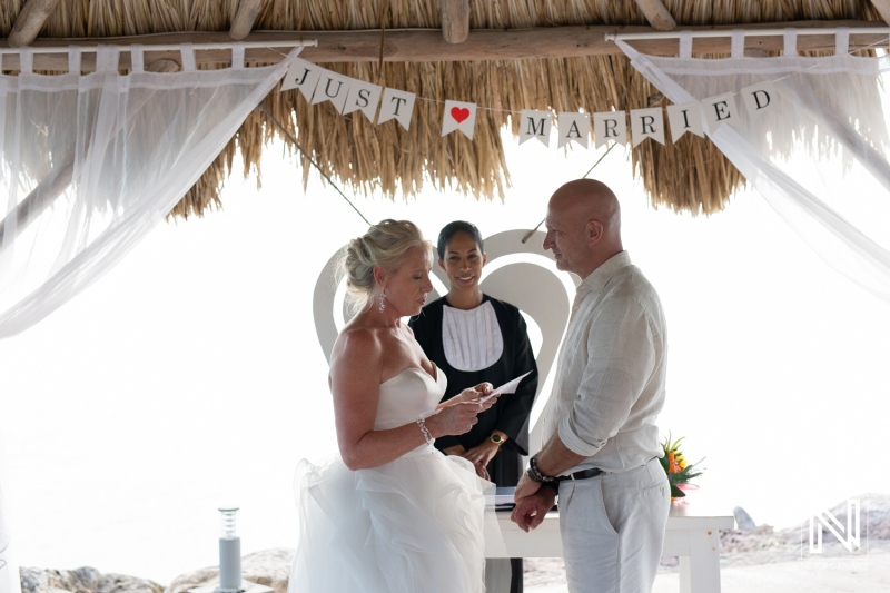 Curacao wedding ceremony at Karakter beach with a couple exchanging vows under a decorated gazebo