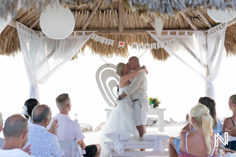 Couple shares a romantic moment after being pronounced married at a picturesque wedding venue in Curacao