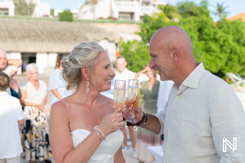 Couple celebrates their wedding at Karakter in Curacao with champagne toasting among joyful guests