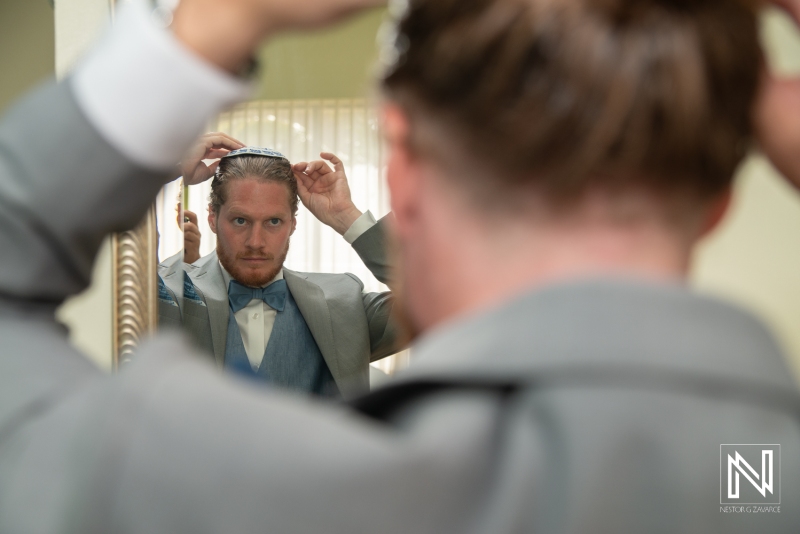 Groom getting into attire