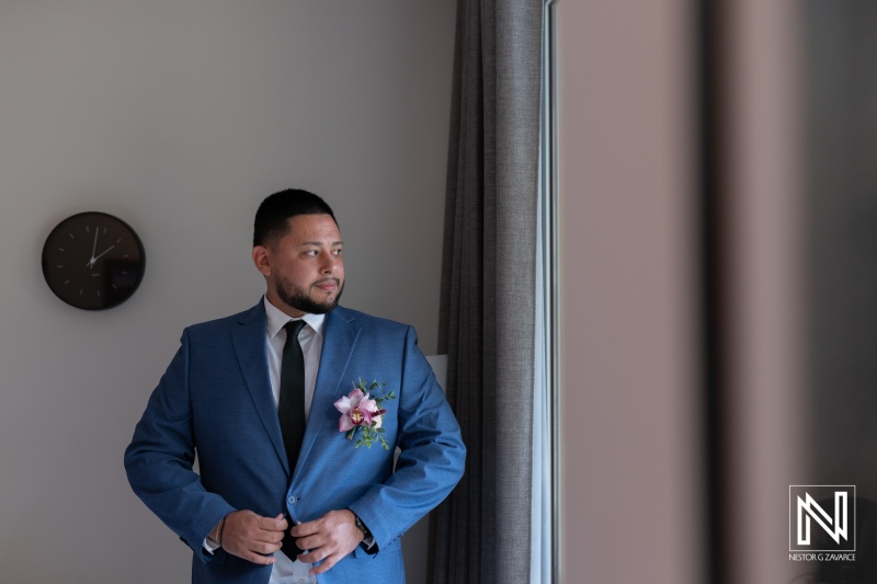 Groom getting ready for wedding at Avila Beach Hotel in Curacao, tropical setting enhancing the special occasion