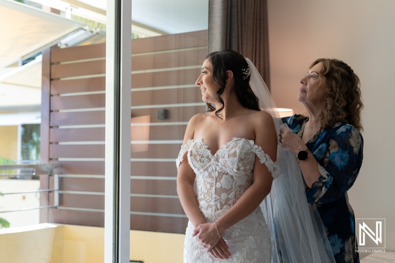 Beautiful bride preparing for her wedding at Avila Beach Hotel in Curacao, showcasing an intimate moment with her mother