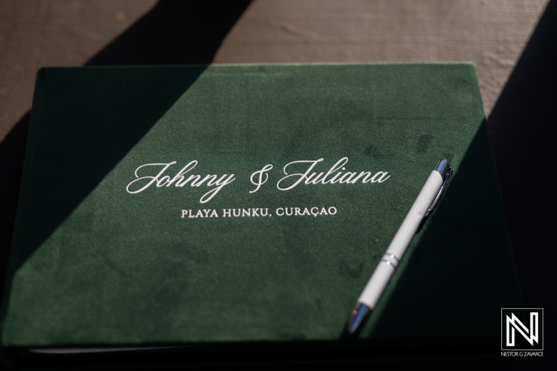 Wedding guestbook rests on a table at Playa Hunku in Curacao for Johnny and Juliana's special day surrounded by tropical beauty