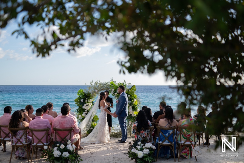 Curacao wedding ceremony at Playa Hunku featuring beautiful decorations and an intimate gathering of friends and family by the ocean