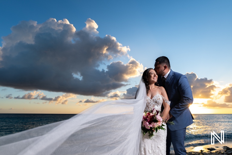 Celebrating love with a stunning wedding at Playa Hunku in Curacao during sunset with a beautiful ocean backdrop