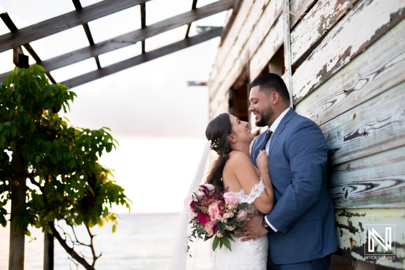 Couple exchanges vows during a romantic wedding at Playa Hunku in Curacao, capturing the essence of love and commitment by the waterfront