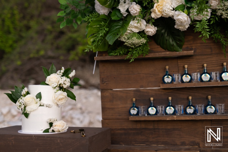 Beautiful wedding cake adorned with white flowers at Playa Hunku in Curacao, creating a stunning backdrop for the celebration