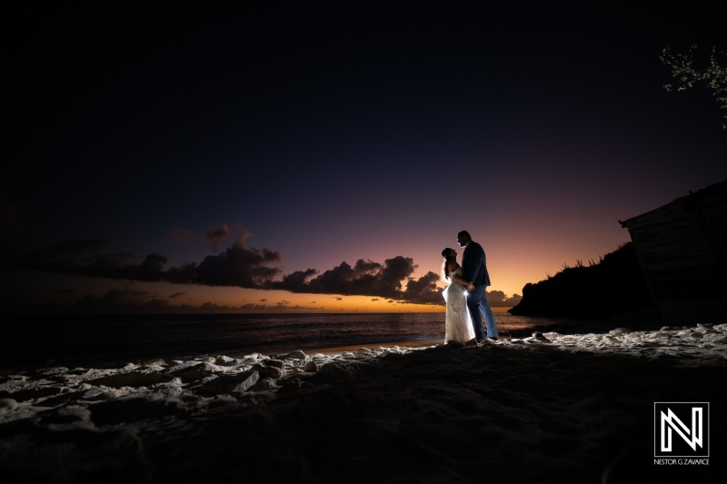 Wedding couple enjoying a romantic moment on Playa Hunku in Curacao during a stunning sunset