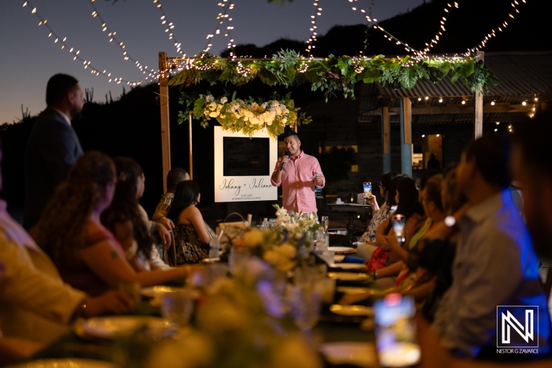 Celebrating love at a wedding reception in Curacao's Playa Hunku as guests enjoy the ambiance under twinkling lights