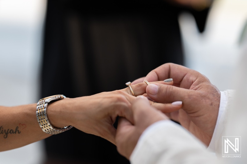 A Couple Exchanging Wedding Rings During a Romantic Beach Ceremony at Sunset, Capturing a Moment of Love and Commitment on Their Special Day