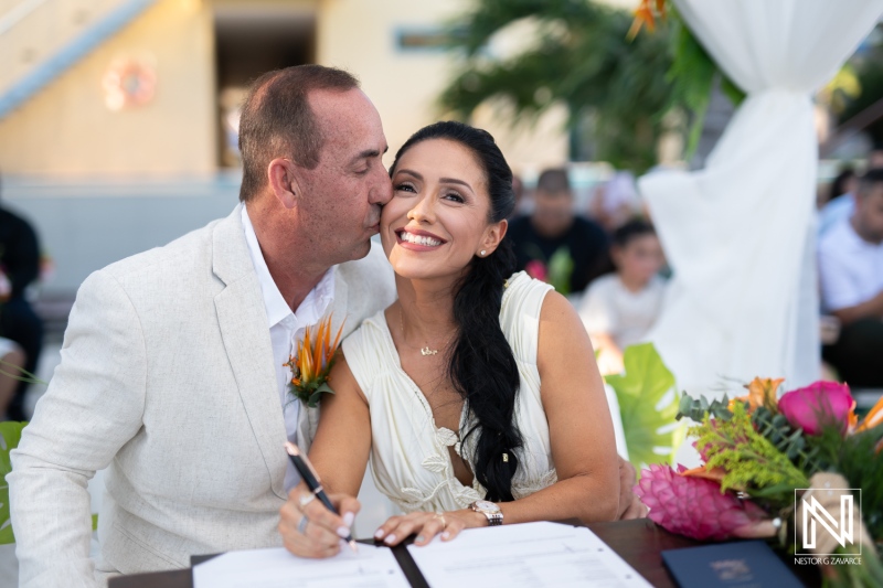 A Joyful Couple Celebrating Their Wedding Ceremony at a Scenic Outdoor Venue, Surrounded by Friends and Family During Sunset